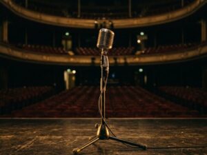 sujatha mohan throat issue — a vintage studio microphone in golden stage light symbolizing five years of silence from one of South India's greatest playback singers