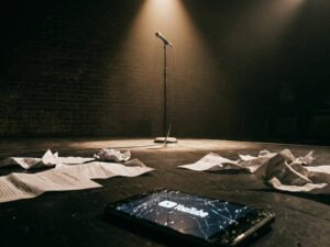 samay raina issue — empty comedy stage with spotlight on microphone representing India's Got Latent controversy