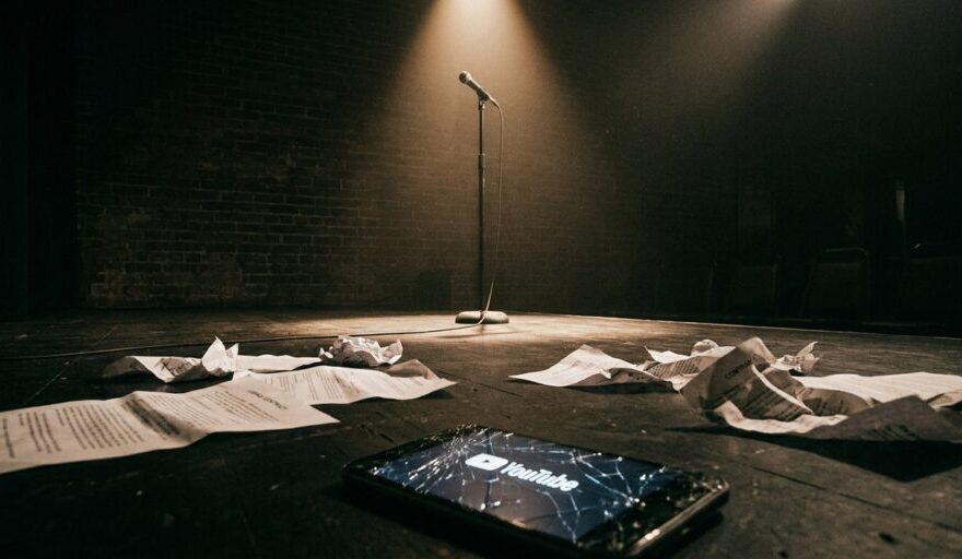 samay raina issue — empty comedy stage with spotlight on microphone representing India's Got Latent controversy